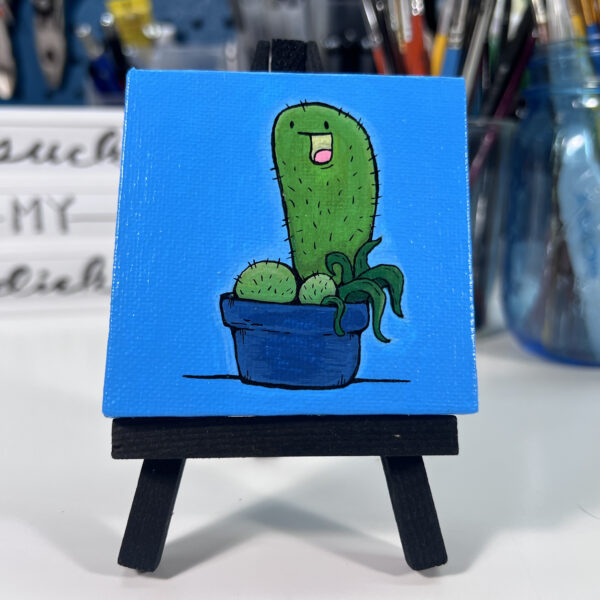 Cactus sitting in a blue pot painting sitting on an easel